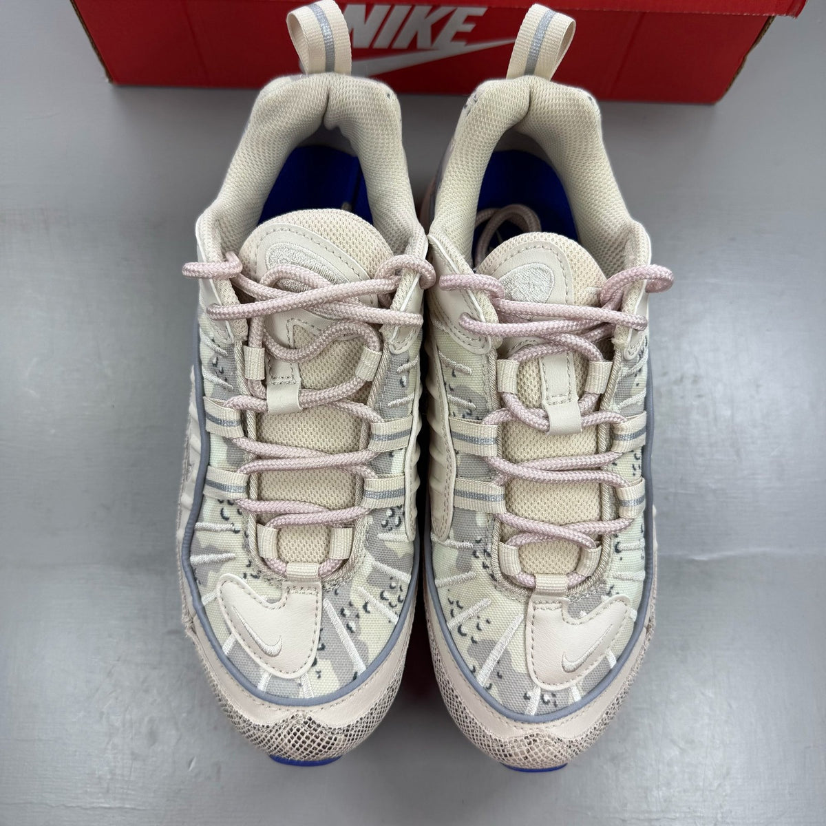 Nike Air Max 98 grey trainers with snakeskin camo pattern and logo detail.