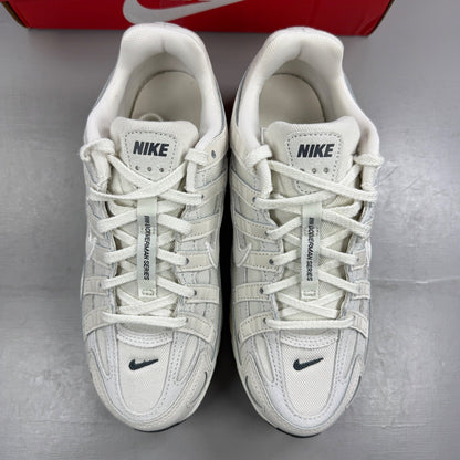 Nike beige athletic shoes with white accents and light bone detailing.