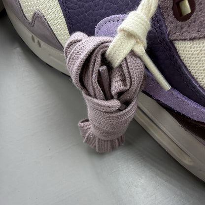 Nike Air Max 1 87 trainers grey with violet accents and signature swoosh logo.