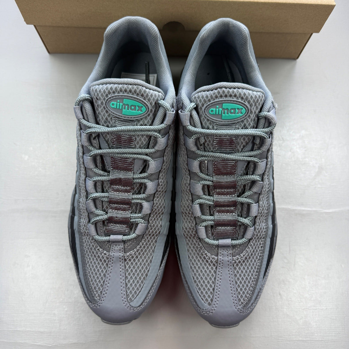 Nike running shoes grey with black accents and signature logo on the side.