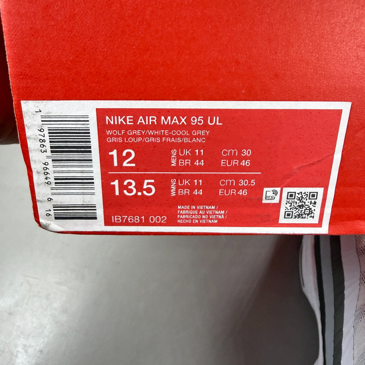 Nike running shoes white with grey accents and Air Max cushioning design.