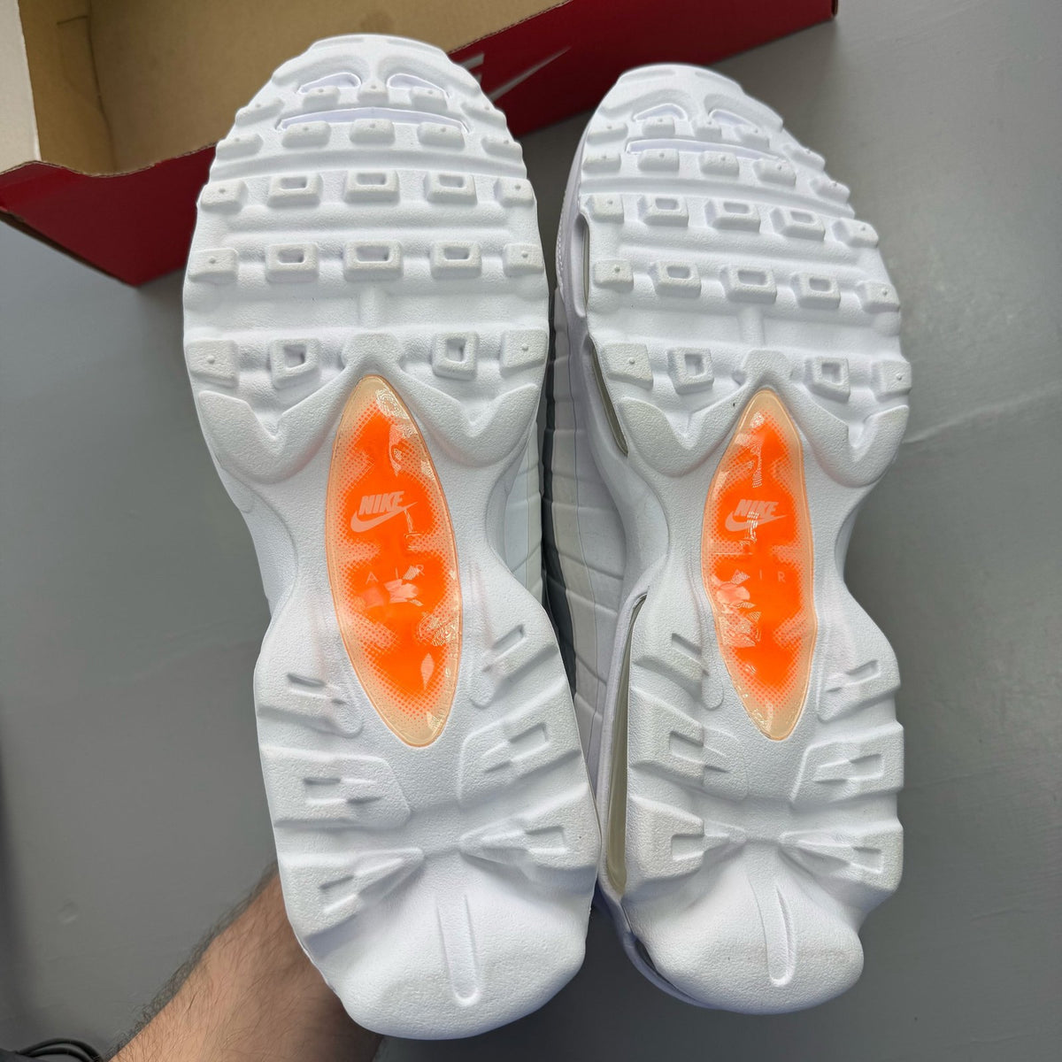 Nike Air Max 95 white trainers with grey accents and signature swoosh logo.
