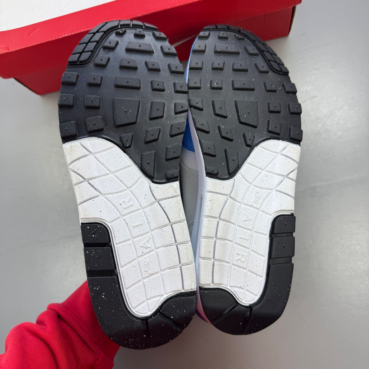 Nike running shoes blue with white accents and Air Max cushioning.