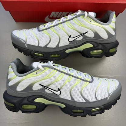 Nike Air Max Plus TN grey trainers with white and liquid lime accents, logo detail.
