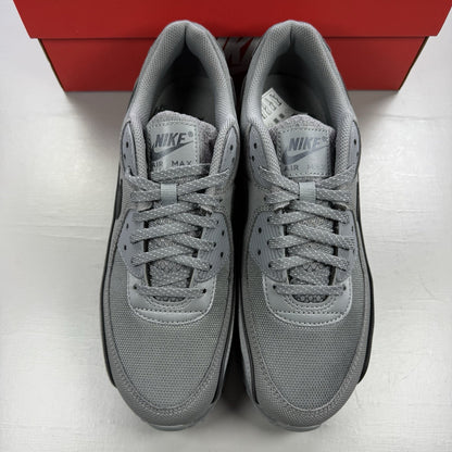 Nike Air Max 90 Premium grey trainers with black accents and signature swoosh logo.