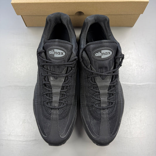Nike black trainers with light grey accents and signature Air Max cushioning.