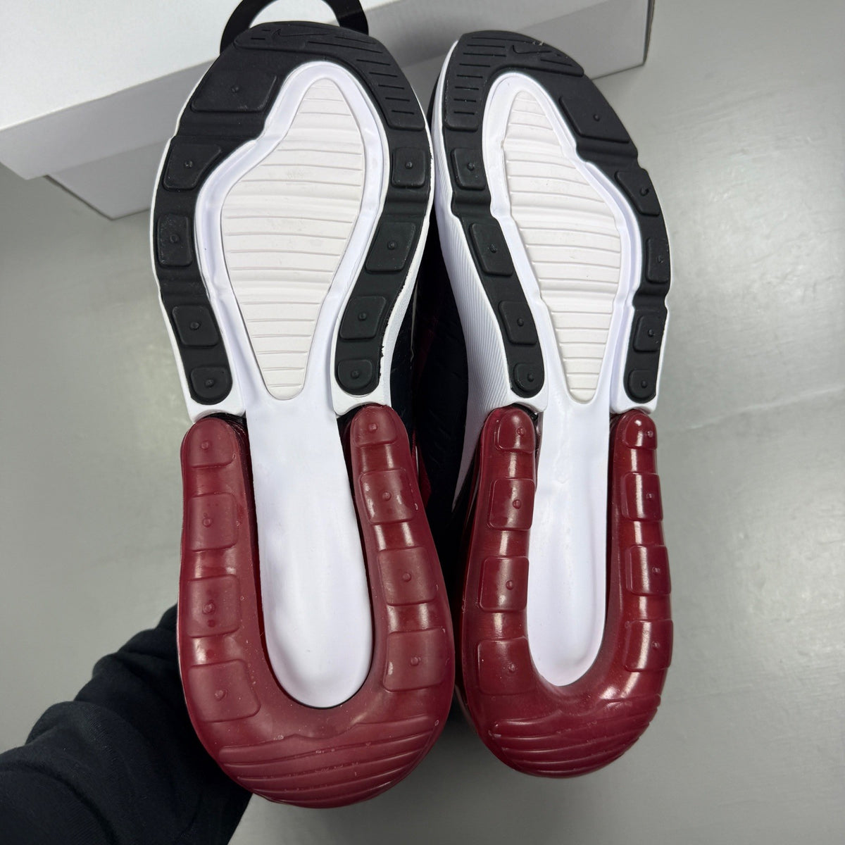 Nike trainers red with black and white accents, featuring Air Max cushioning and logo.