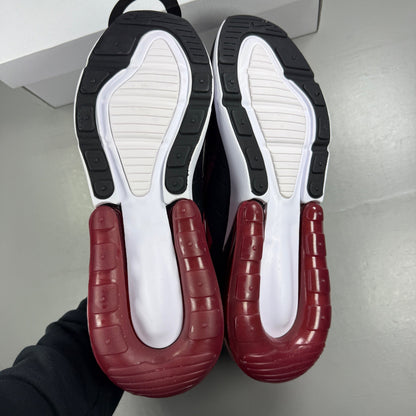 Nike trainers red with black and white accents, featuring Air Max cushioning and logo.