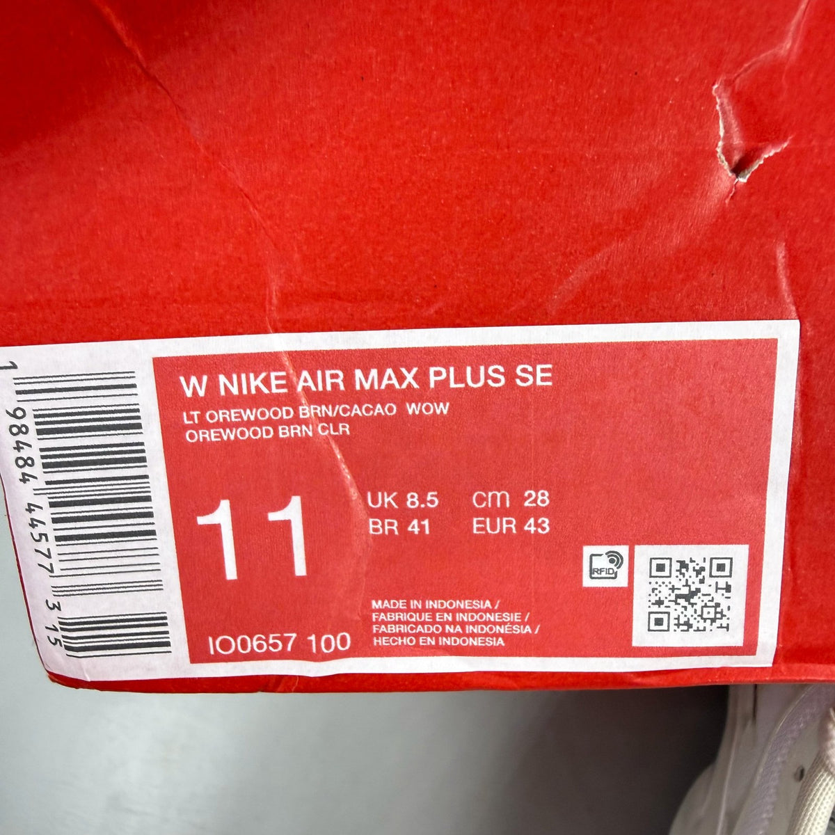 Nike Air Max Plus TN white trainers with signature logo and textured detailing.