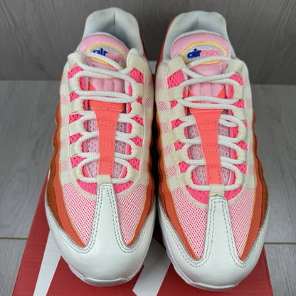 Nike Air Max 95 trainers white with campfire orange accents and signature logo details.