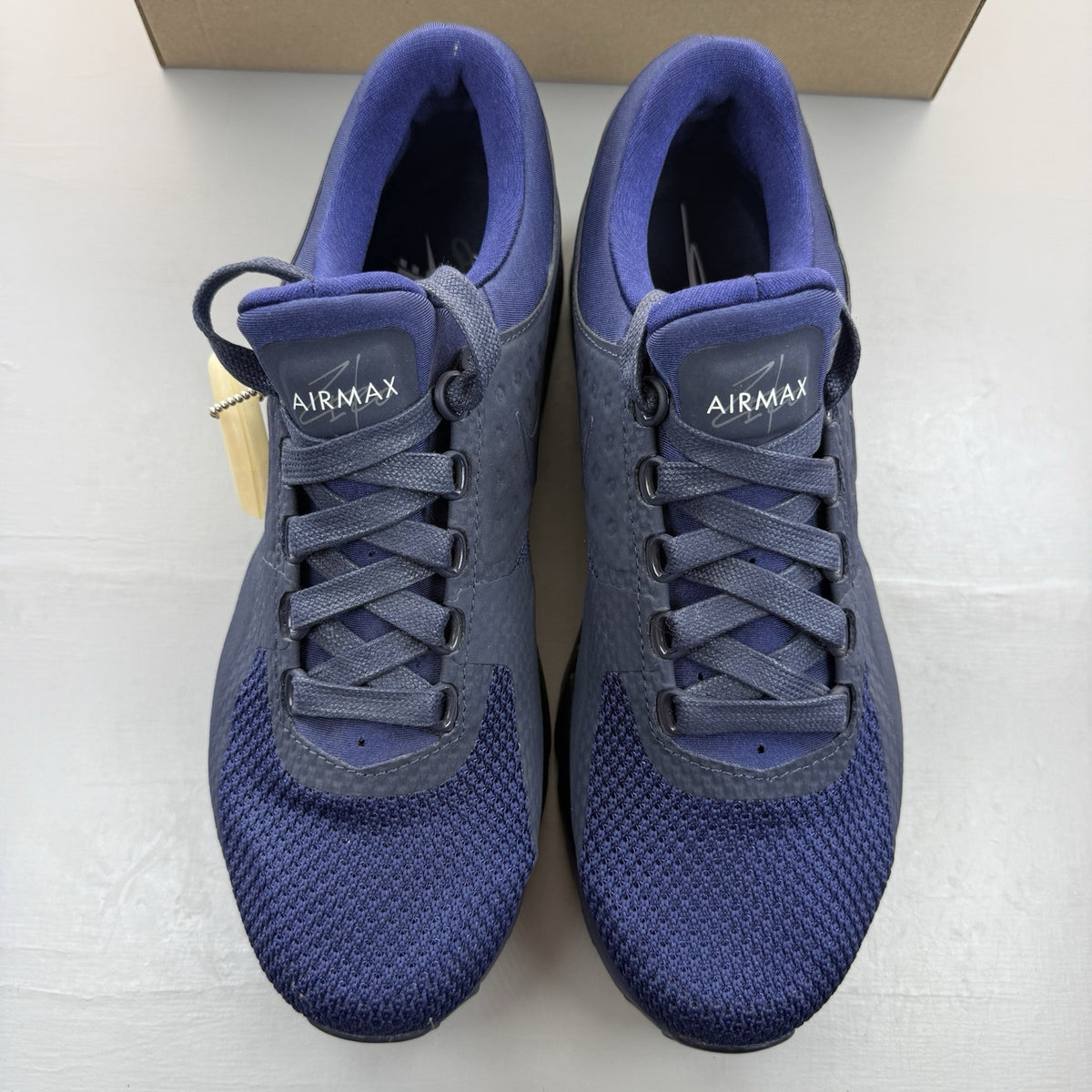Nike Air Max Zero blue trainers with black accents and logo detailing.