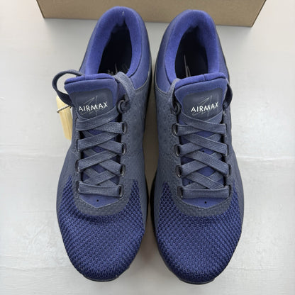 Nike Air Max Zero blue trainers with black accents and logo detailing.