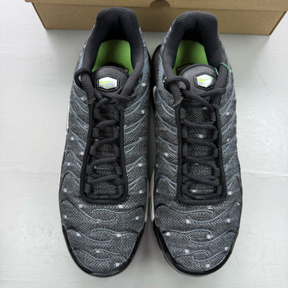 Nike Air Max Plus TN black trainers with chrome accents and distinctive wave pattern.