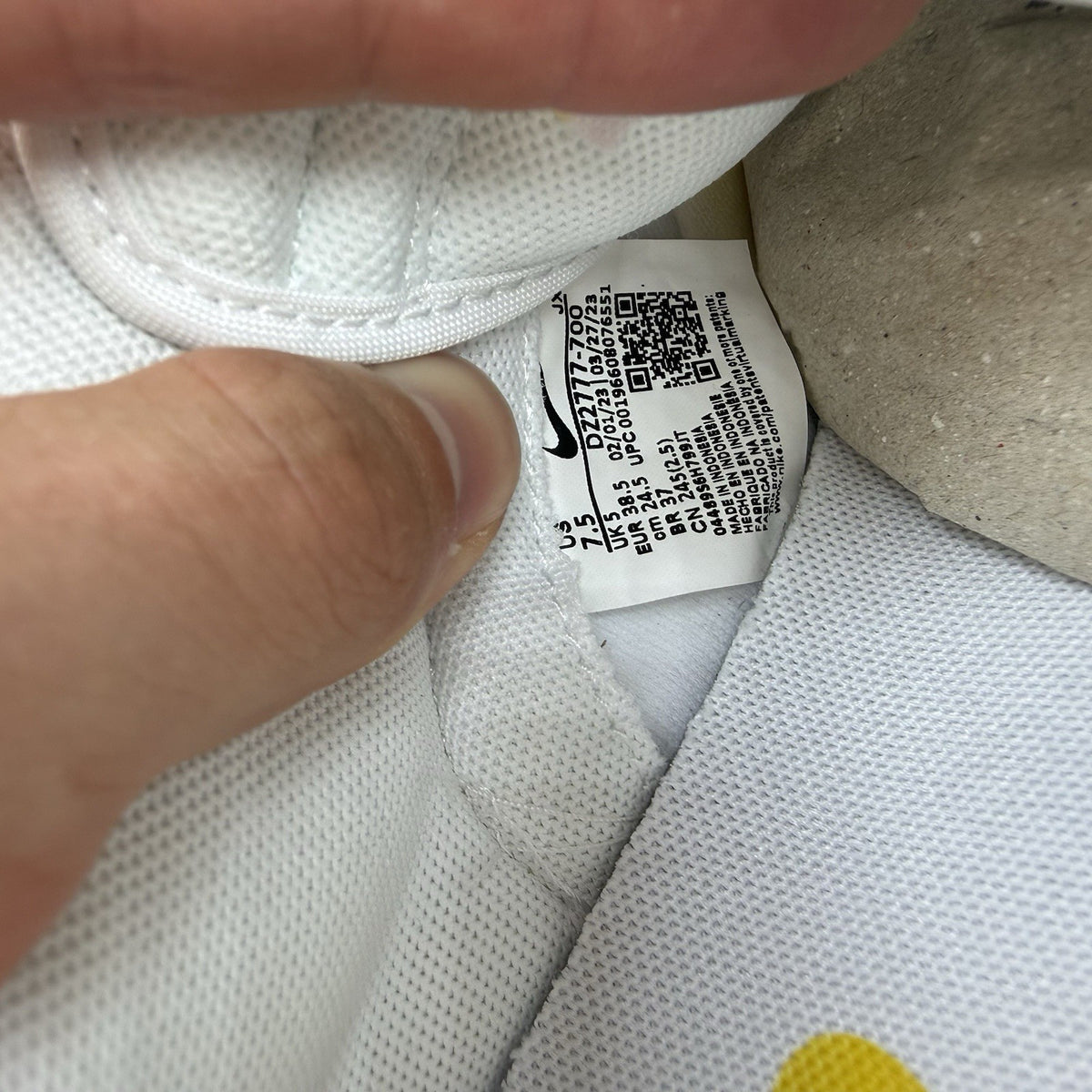 Nike Dunk Low white trainers with yellow gingham pattern and brown gum sole.