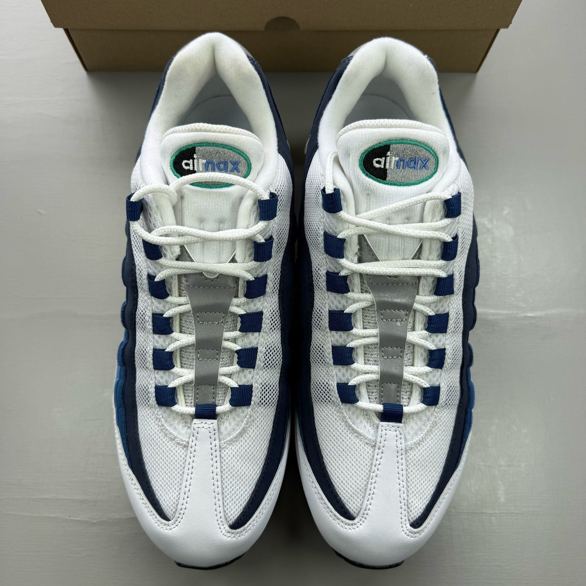 Nike Air Max 95 white trainers with big bubble design and emerald accents.