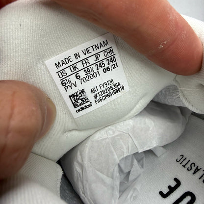 Adidas Ultra Boost 4.0 DNA white trainers with black accents and signature three-stripe logo.