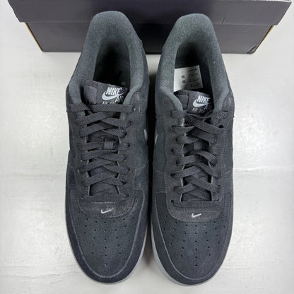 Nike Air Force 1 black trainers with cool grey accents and jewel detailing.