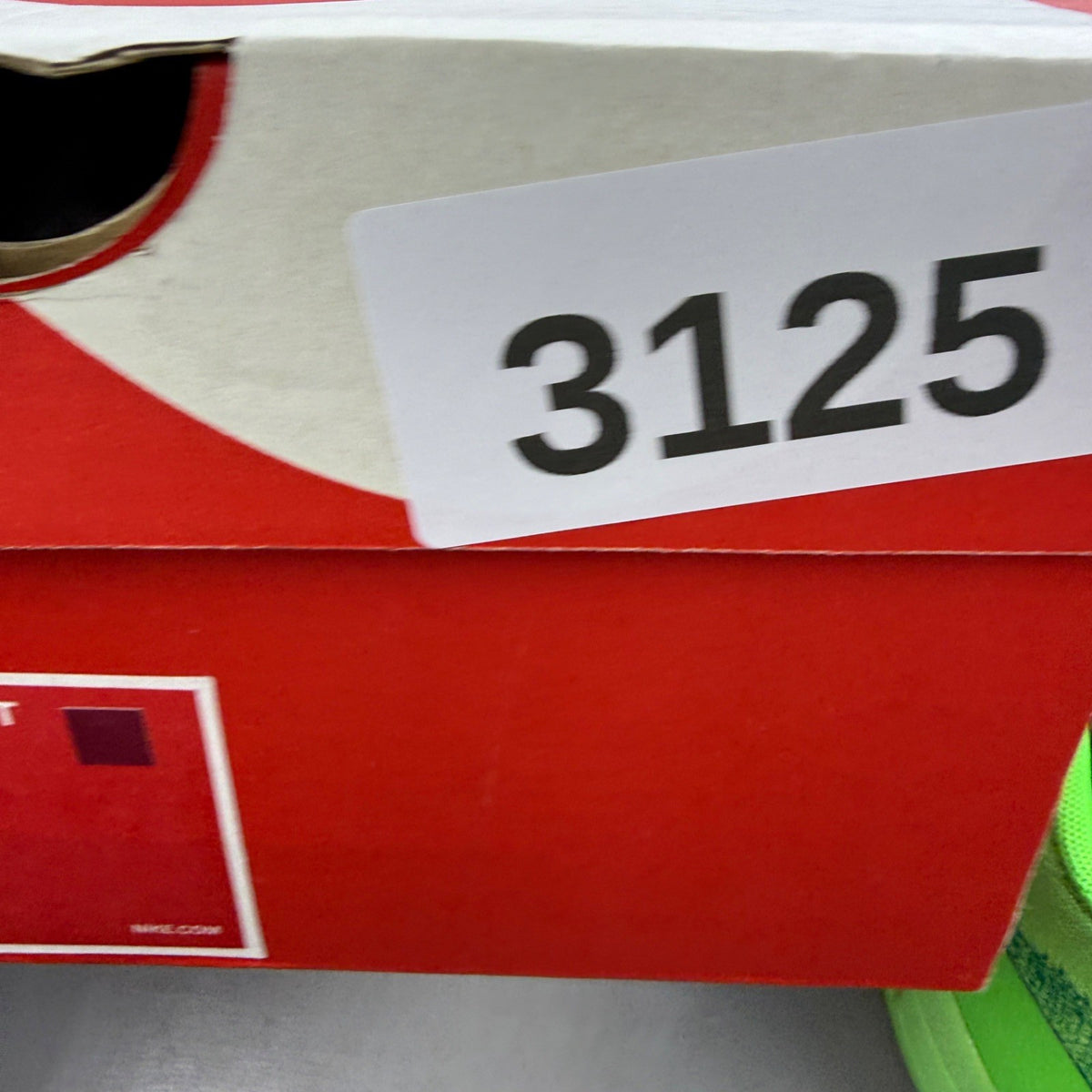 Nike trainers green Flyknit upper with Air Max cushioning and logo detail.