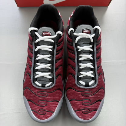 Nike Air Max Plus TN red trainers with grey and black accents, featuring signature logo.