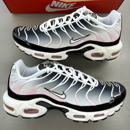 Nike trainers white with pink accents and black detailing, featuring Air Max cushioning.