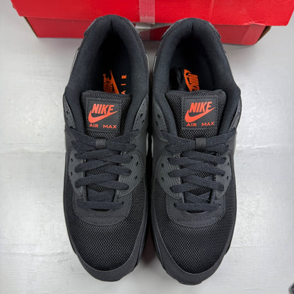 Nike Air Max 90 black sneakers with total orange accents and reflective silver details.