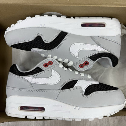 Nike Air Max 1 trainers grey with white accents and signature swoosh logo.