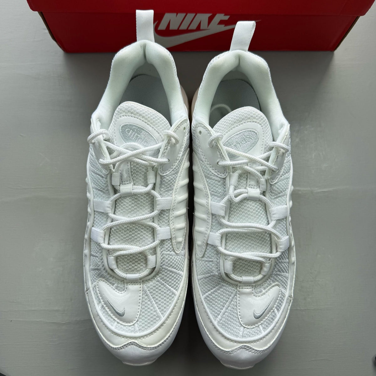 Nike Air Max 98 white trainers with platinum accents and signature swoosh logo.