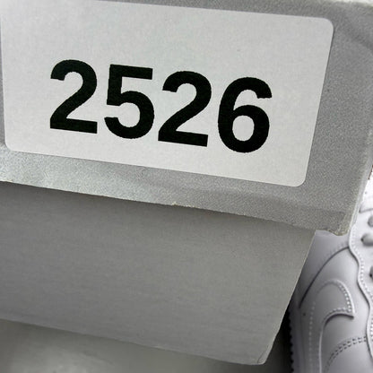 Nike Air Force 1 '07 white trainers with classic silhouette and embossed logo.