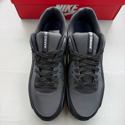Nike Air Max 90 black sneakers with reflective silver accents and logo.
