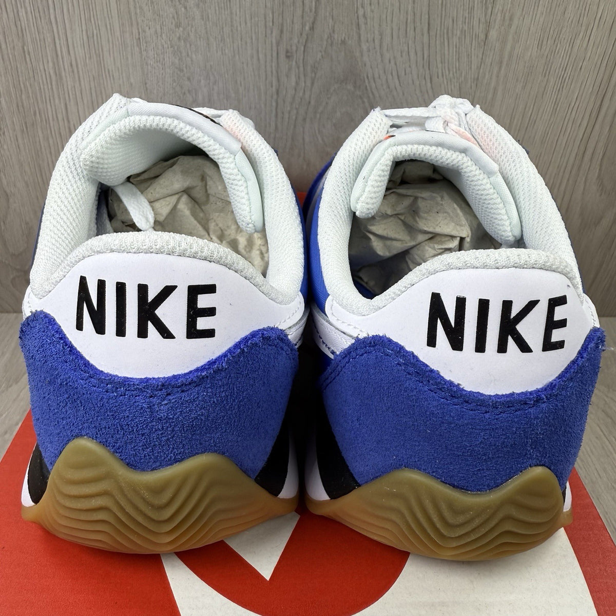 Nike blue trainers with white swoosh logo and mesh upper details.