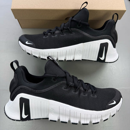 Nike black trainers with white accents and breathable mesh upper.