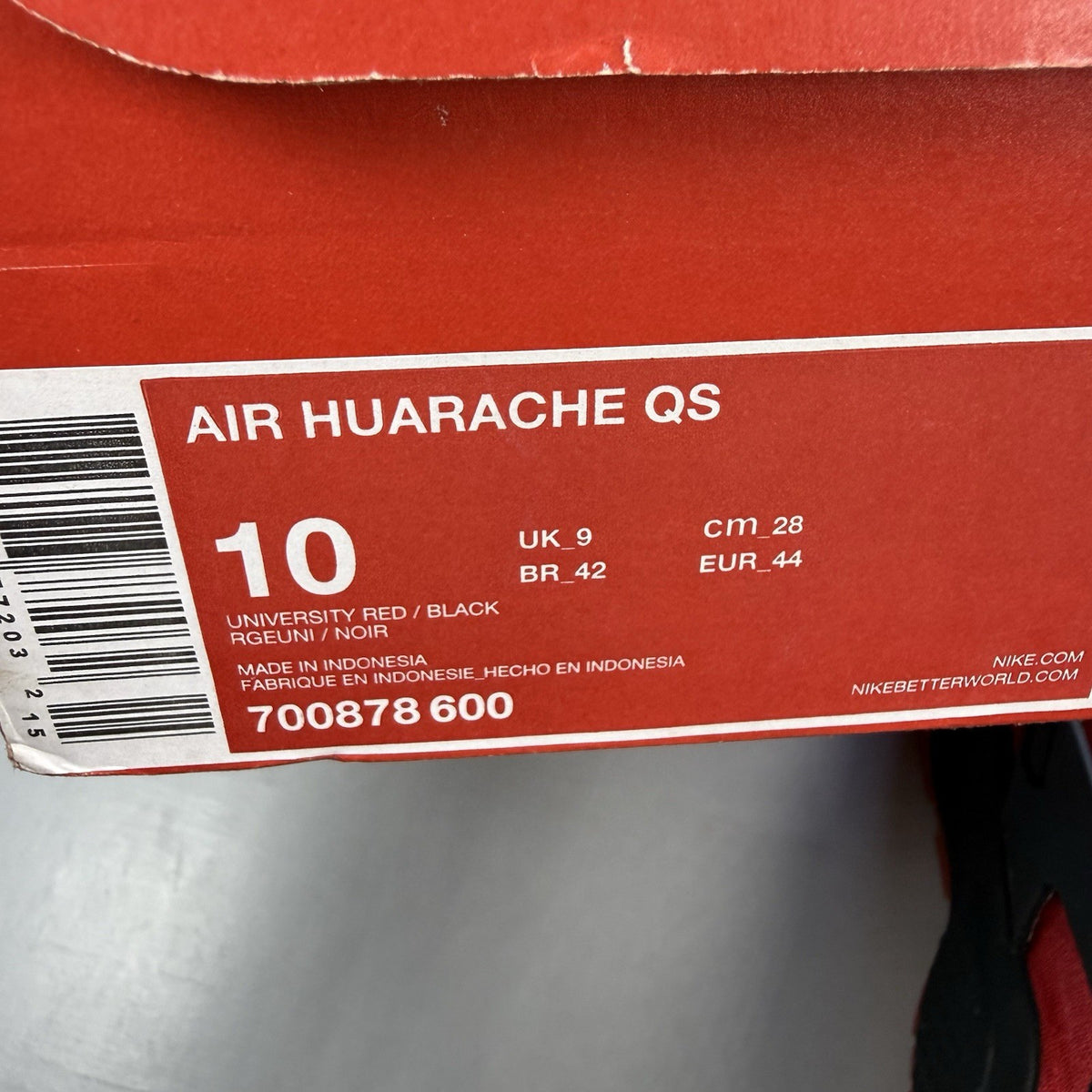 Nike Air Huarache trainers red and black with distinctive logo and unique design details.