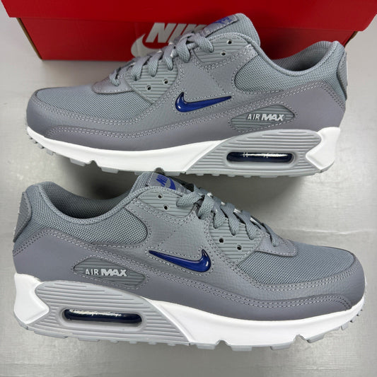 Nike athletic shoes grey with blue accents and Air Max logo detail.