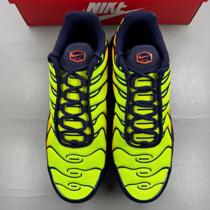 Nike yellow trainers with Hyper Crimson accents and distinctive Air Max Plus design.