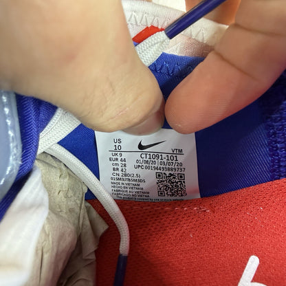 Nike Air Max 2090 trainers white with red and blue accents, featuring logo details.