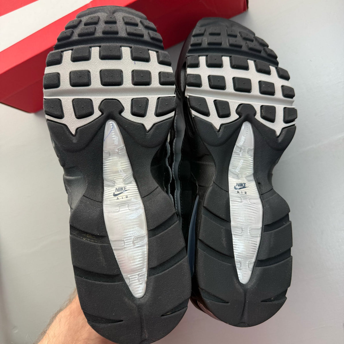 Nike Air Max 95 black sneakers with metallic silver accents and big bubble sole design.