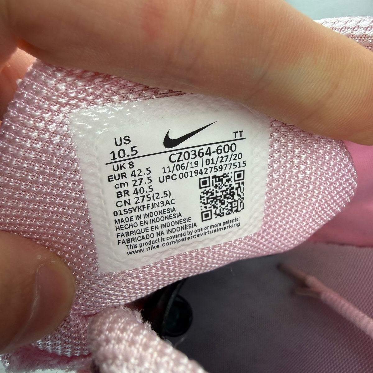 Nike Air Max 270 React white trainers with pink accents and logo detail.