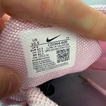 Nike Air Max 270 React white trainers with pink accents and logo detail.