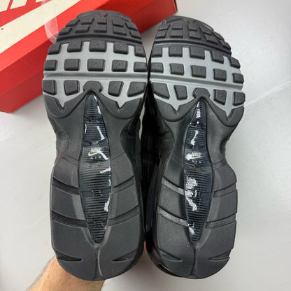 Nike black trainers with grey accents and signature swoosh logo, size UK 9.5.