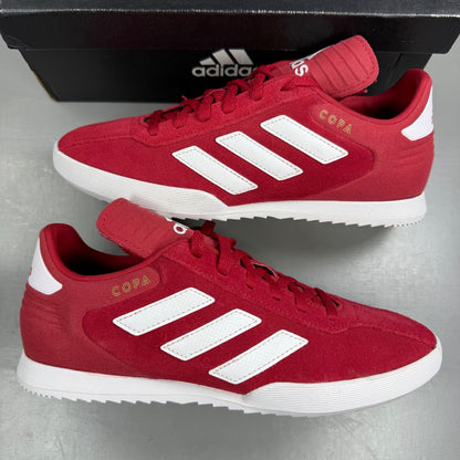 Adidas red suede running trainers with white logo and classic design details.