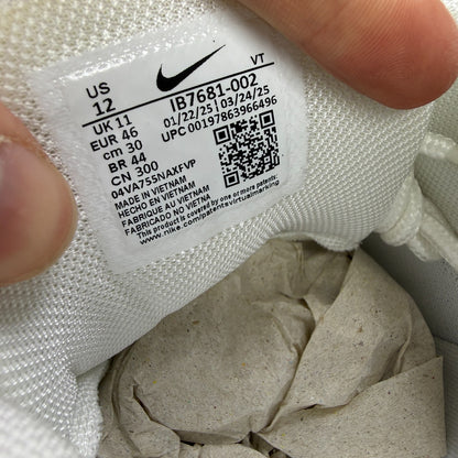 Nike running shoes white with grey accents and Air Max cushioning design.