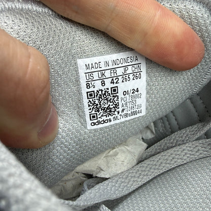 Adidas grey athletic shoes with white accents and classic three-stripe logo.