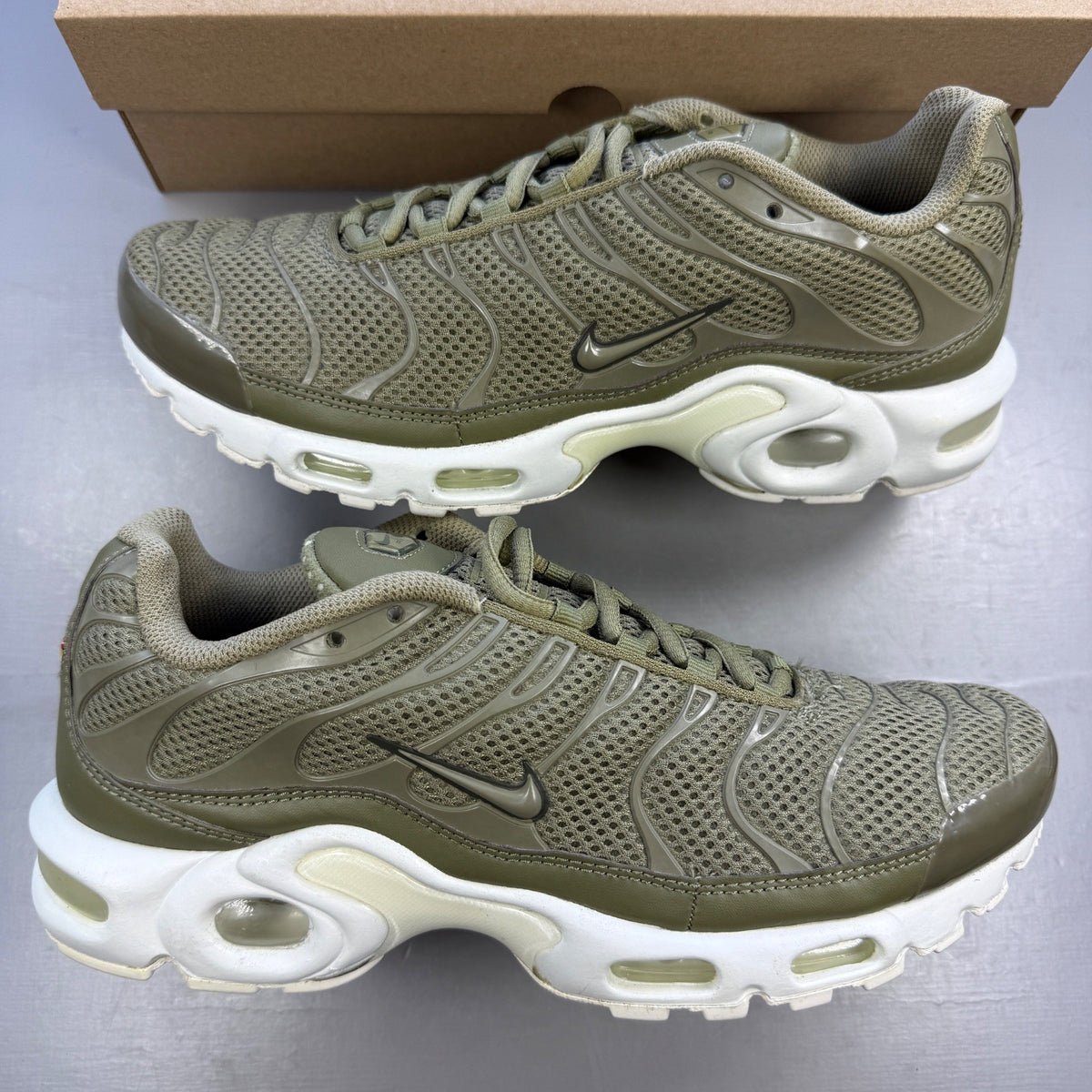 Nike trainers green with Air Max Plus design and signature logo details.