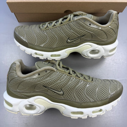Nike trainers green with Air Max Plus design and signature logo details.