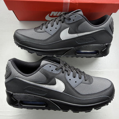 Nike Air Max 90 black sneaker with reflective silver accents and logo details.