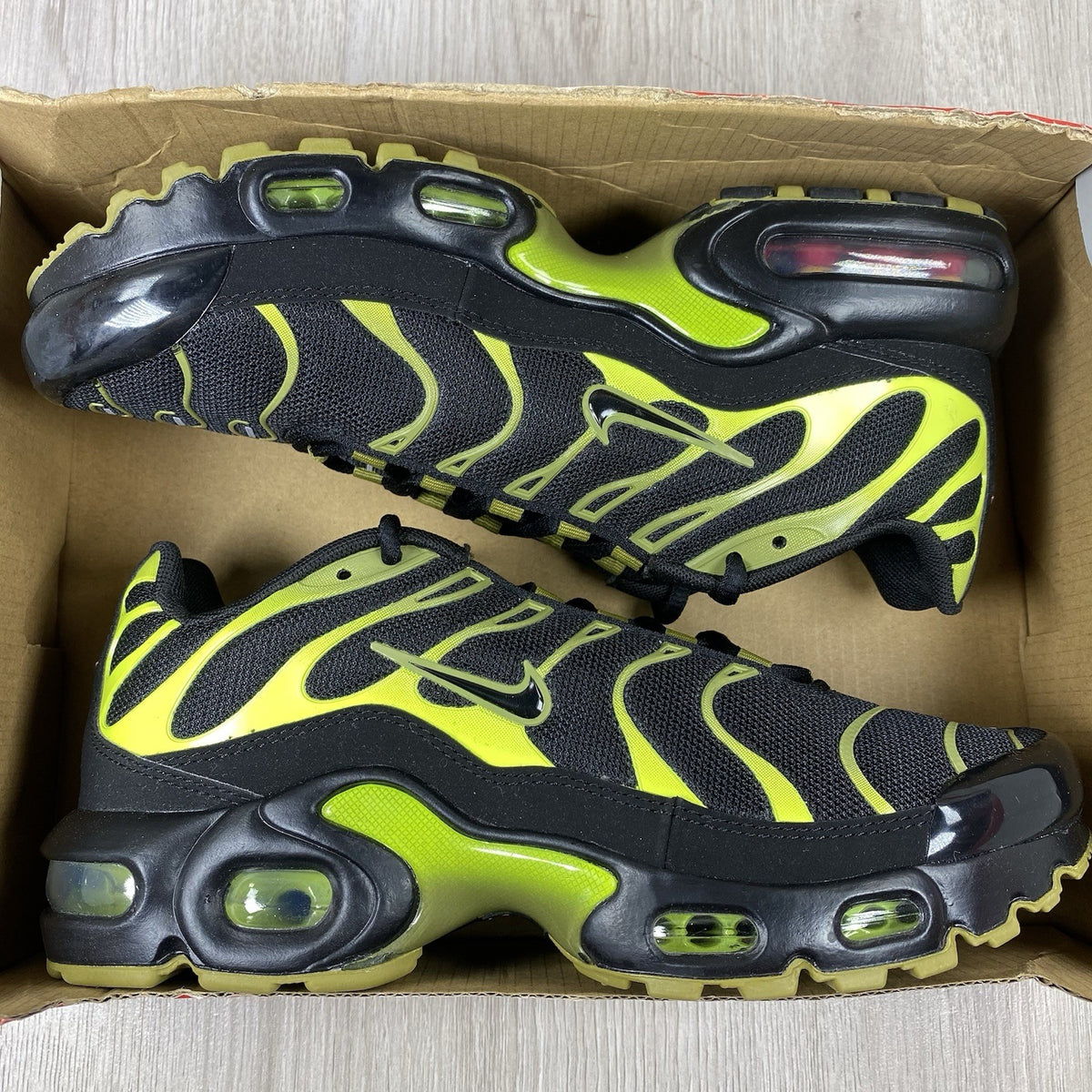 Nike Air Max Plus TN trainers black with cyber accents and mesh upper detailing.