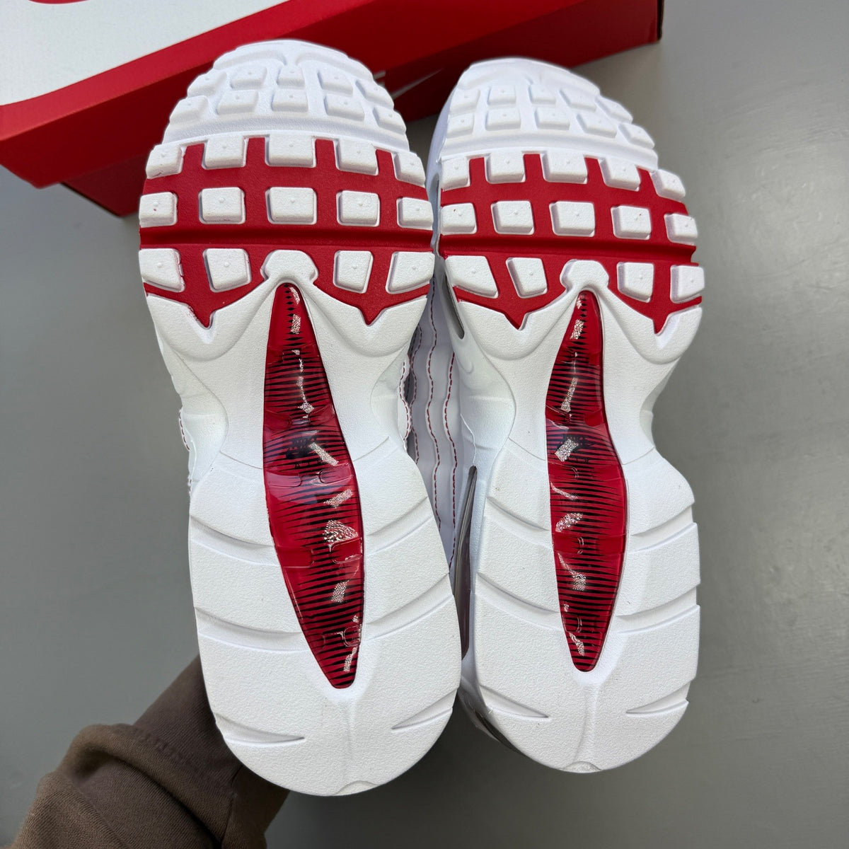 Nike trainers white with red accents and big bubble sole design.