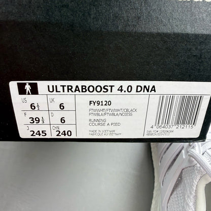 Adidas Ultra Boost 4.0 DNA white trainers with black accents and signature three-stripe logo.