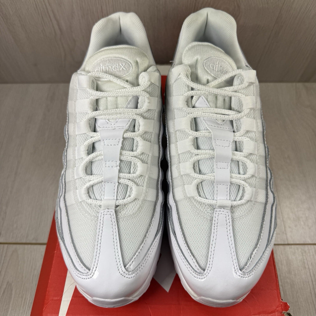 Nike Air Max 95 trainers white mesh upper with signature swoosh logo and reflective details.