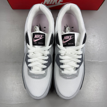 Nike Air Max 90 grey trainers with pink accents and white sole, featuring logo detail.